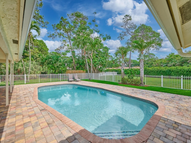 view of pool featuring a fenced in pool, a patio area, a lawn, and a fenced backyard