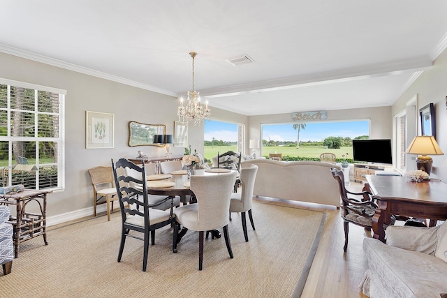 dining room featuring a notable chandelier, visible vents, baseboards, light wood-type flooring, and crown molding