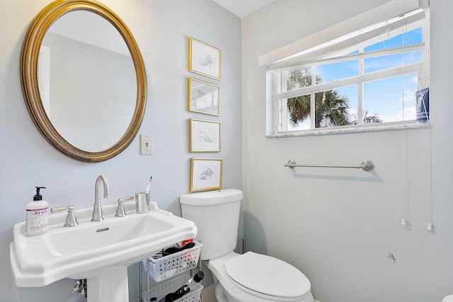 bathroom with toilet and a sink