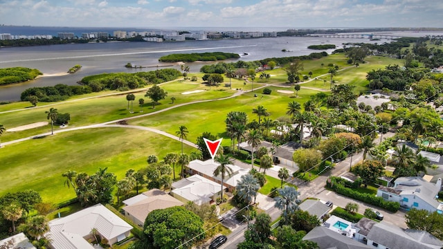 birds eye view of property featuring view of golf course and a water view