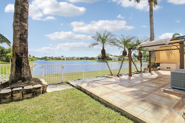 view of yard with a patio area, fence, a water view, and central AC unit