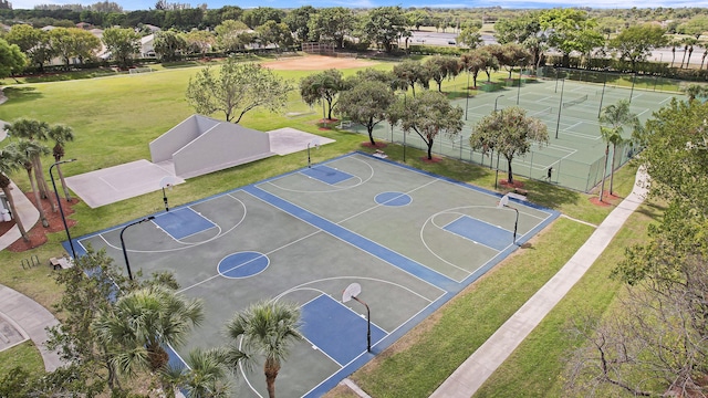 view of sport court featuring a yard, community basketball court, and fence