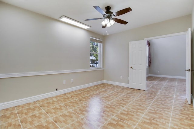 empty room with baseboards and a ceiling fan