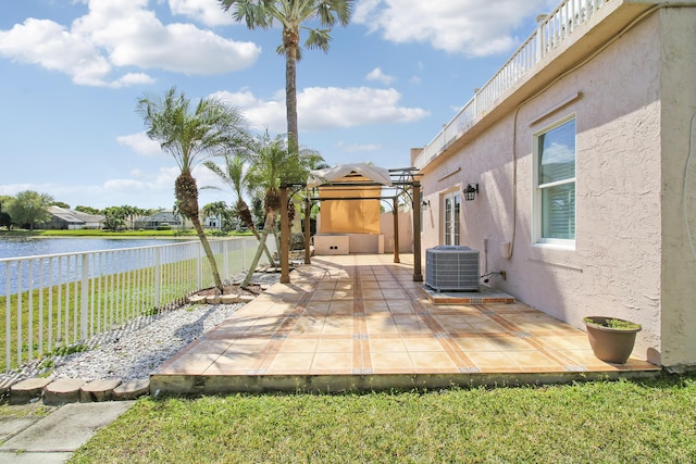 view of patio / terrace featuring central AC unit, a water view, and fence