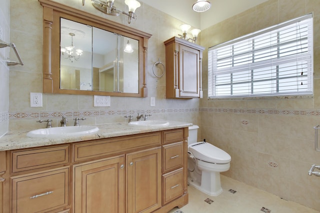 bathroom with a sink, tile walls, toilet, and tile patterned floors