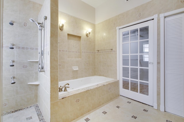 bathroom featuring tiled tub, a closet, tiled shower, and tile patterned flooring