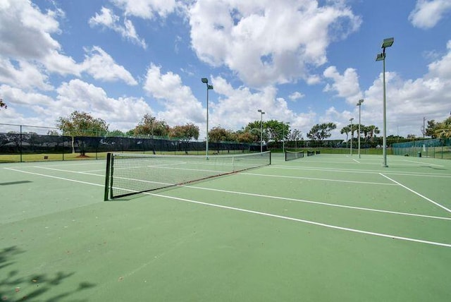 view of sport court featuring fence