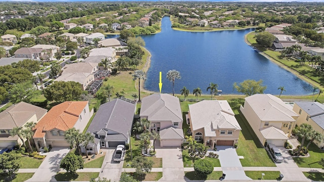 drone / aerial view with a residential view and a water view