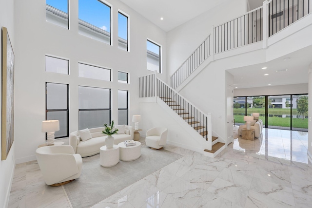 living room featuring recessed lighting, marble finish floor, baseboards, and stairs