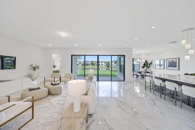 living area featuring marble finish floor and recessed lighting