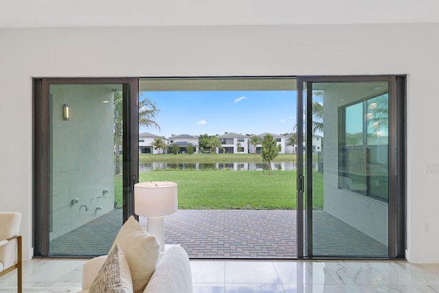 entryway with marble finish floor and a water view