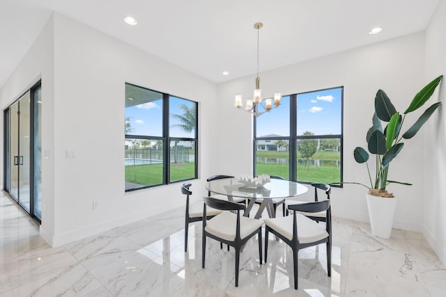 dining room featuring marble finish floor, a wealth of natural light, and recessed lighting