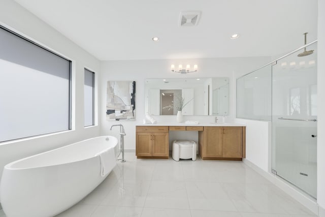 full bath with a freestanding tub, a notable chandelier, recessed lighting, vanity, and a shower stall