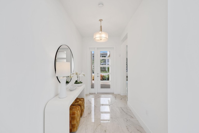 entryway featuring marble finish floor and baseboards