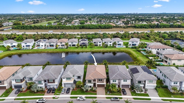 bird's eye view with a water view and a residential view