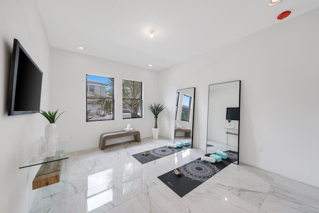 interior space with recessed lighting and marble finish floor