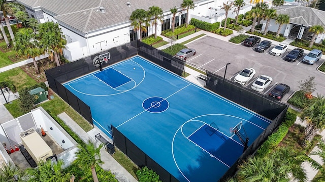 view of basketball court featuring a residential view, community basketball court, and fence