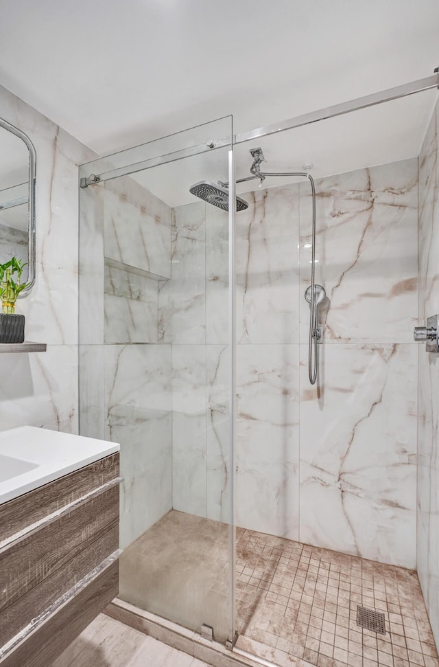 full bath featuring a marble finish shower