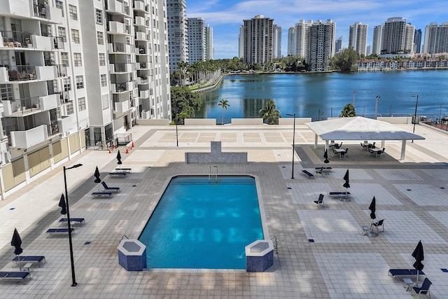 community pool featuring a city view and a water view