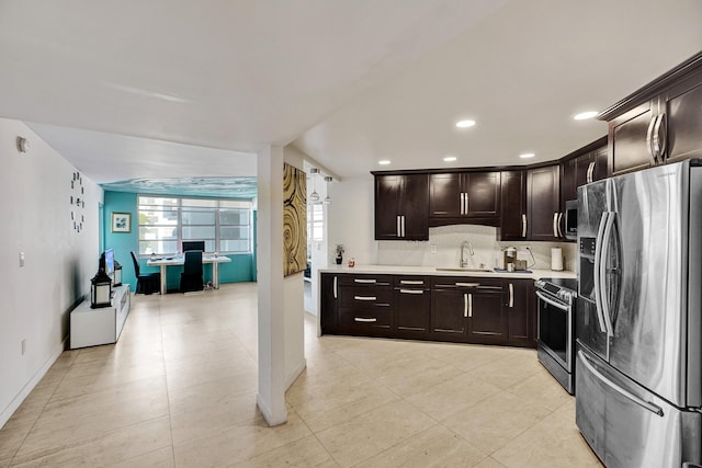 kitchen featuring decorative backsplash, stainless steel appliances, dark brown cabinets, light countertops, and a sink