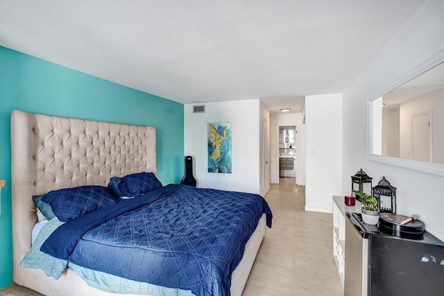 bedroom featuring baseboards and visible vents