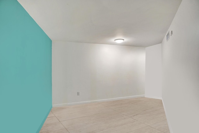 empty room featuring visible vents and baseboards