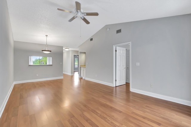 spare room featuring baseboards, visible vents, ceiling fan, a textured ceiling, and light wood-type flooring