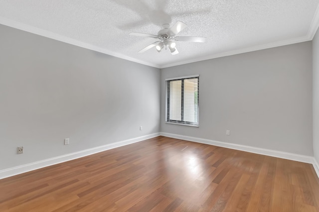 unfurnished room featuring baseboards, crown molding, a ceiling fan, and wood finished floors