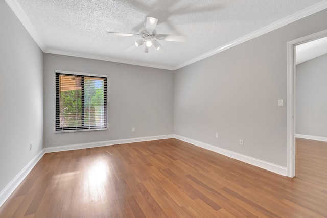 empty room featuring baseboards, a ceiling fan, and wood finished floors