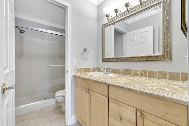 full bathroom with tile patterned flooring, toilet, vanity, ornamental molding, and a shower stall