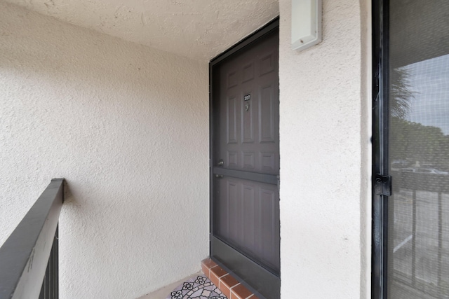 entrance to property with stucco siding