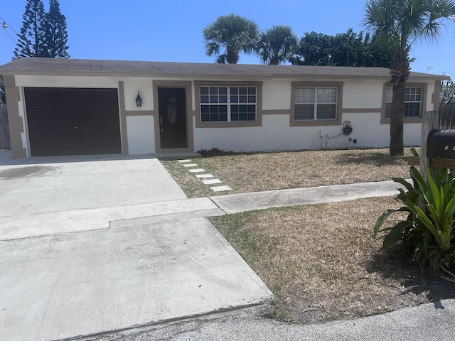 ranch-style house featuring concrete driveway, an attached garage, and stucco siding