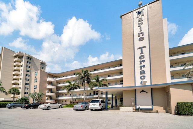 view of building exterior featuring uncovered parking