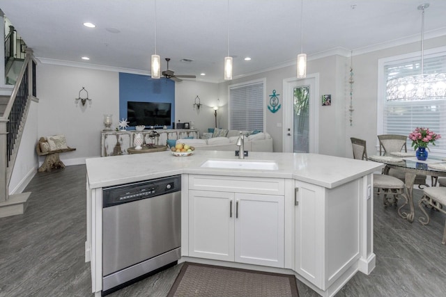 kitchen featuring ornamental molding, open floor plan, hanging light fixtures, stainless steel dishwasher, and a sink