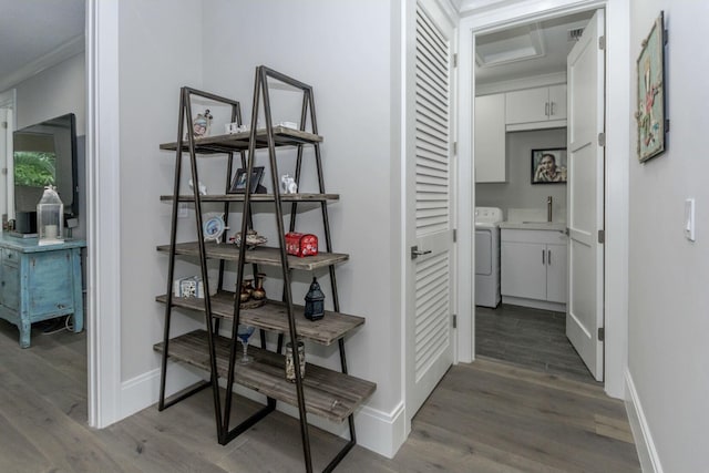 hallway featuring visible vents, baseboards, and wood finished floors