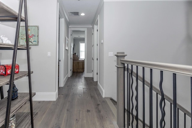 hall with visible vents, baseboards, wood finished floors, an upstairs landing, and recessed lighting