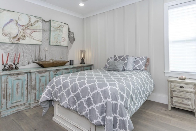 bedroom with recessed lighting, wood finished floors, and crown molding