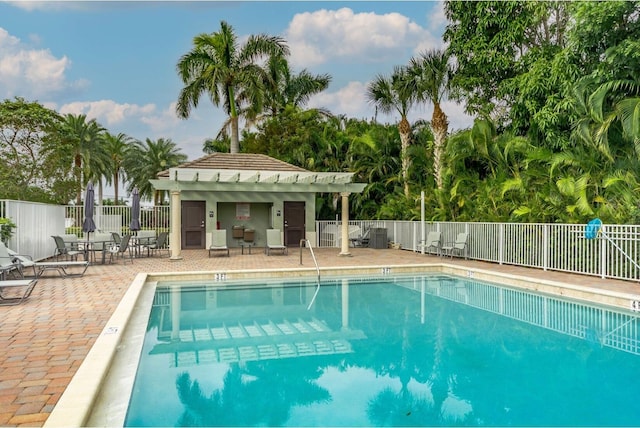 community pool featuring a patio area and fence