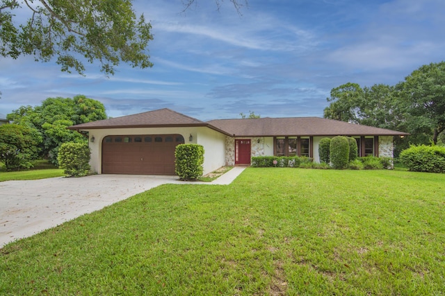 single story home with a garage, concrete driveway, a front lawn, and stucco siding