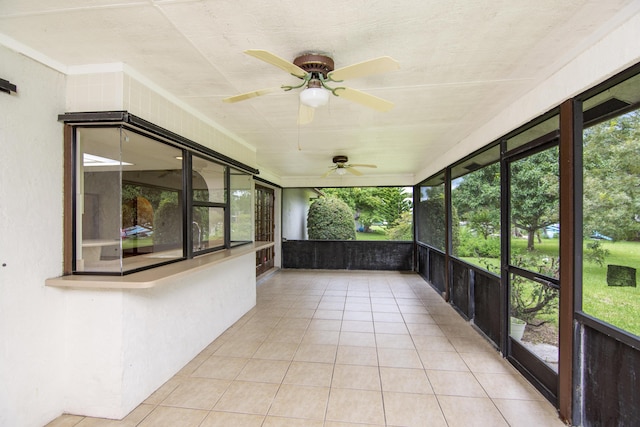 unfurnished sunroom with a ceiling fan