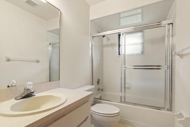 full bath with shower / bath combination with glass door, visible vents, toilet, vanity, and tile patterned floors