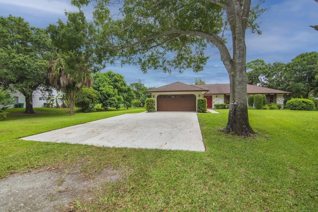 ranch-style home with a front lawn, driveway, and an attached garage