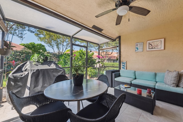 sunroom featuring ceiling fan