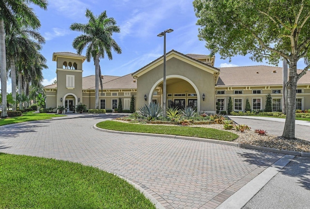 view of building exterior featuring decorative driveway