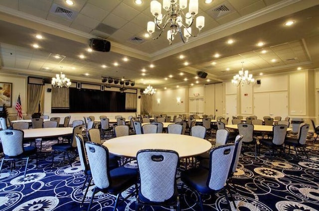 carpeted dining area with crown molding, visible vents, and a notable chandelier