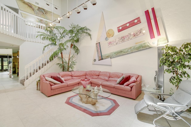 living room featuring stairway and a high ceiling