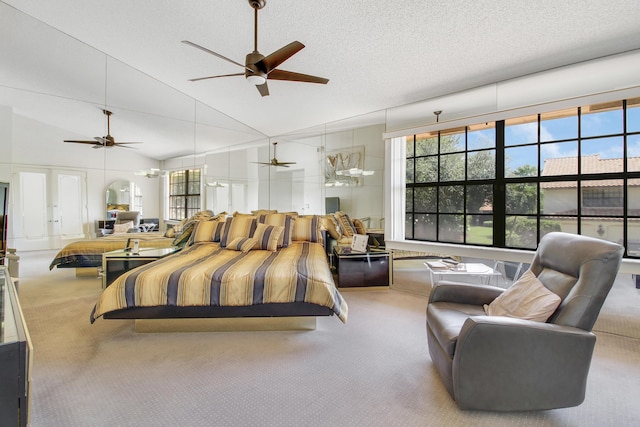 bedroom with a textured ceiling, carpet floors, multiple windows, and high vaulted ceiling