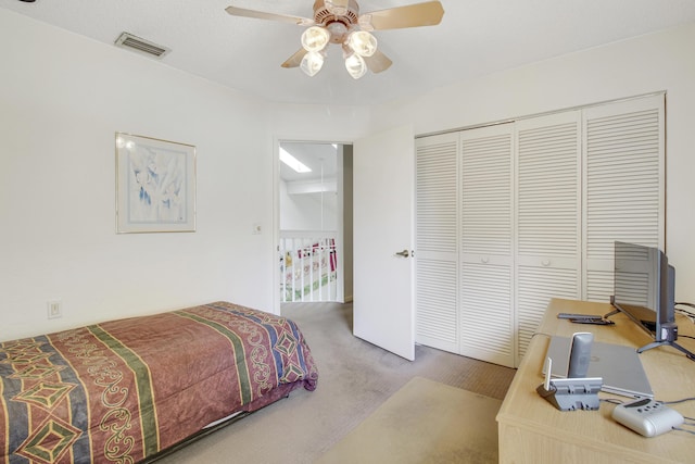 bedroom with carpet floors, ceiling fan, visible vents, and a closet