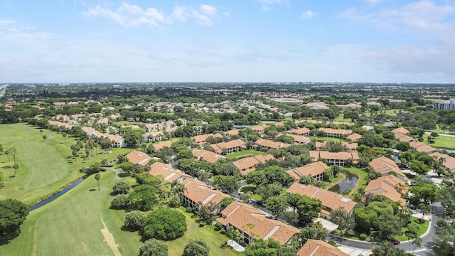 drone / aerial view with view of golf course and a residential view