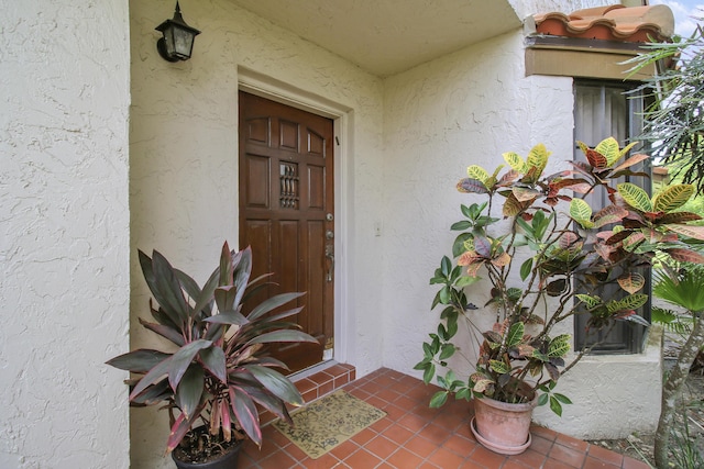 doorway to property with stucco siding